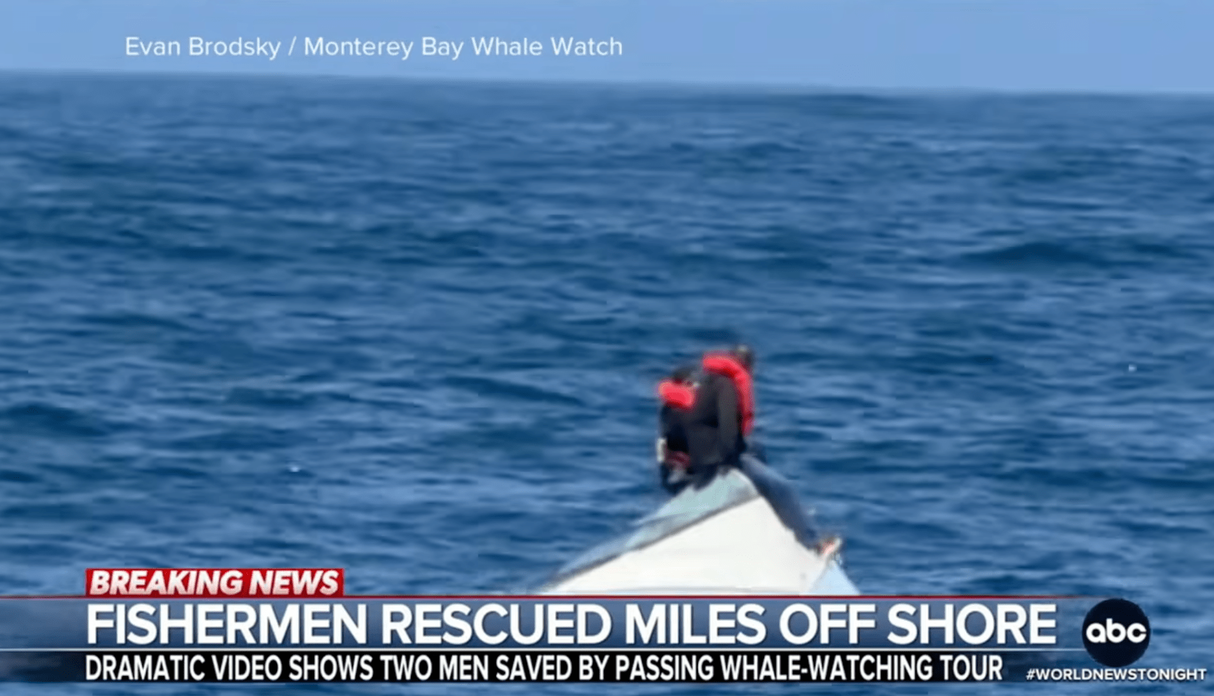 Person on capsized boat in ocean, rescue text overlayed